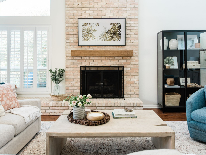 living room interior design brick fireplace wood mantel white sofa fiddle leaf fig tree