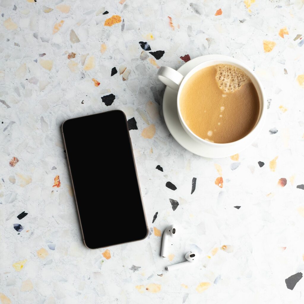 black white gold terrazzo tile with coffee cup and phone