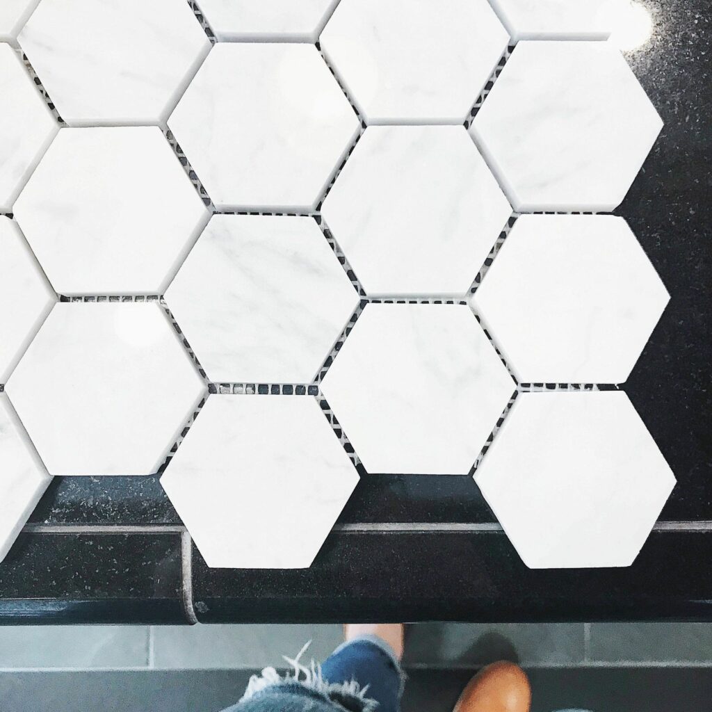 hexagonal tiles honeycomb pattern white on black countertop styleberry