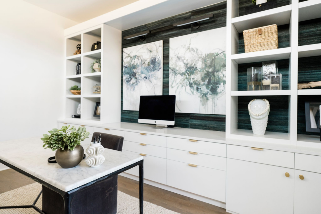 professional home office design with desk built-in shelving storage blue wallpaper art interior design investment styleberry creative interiors san antonio texas
