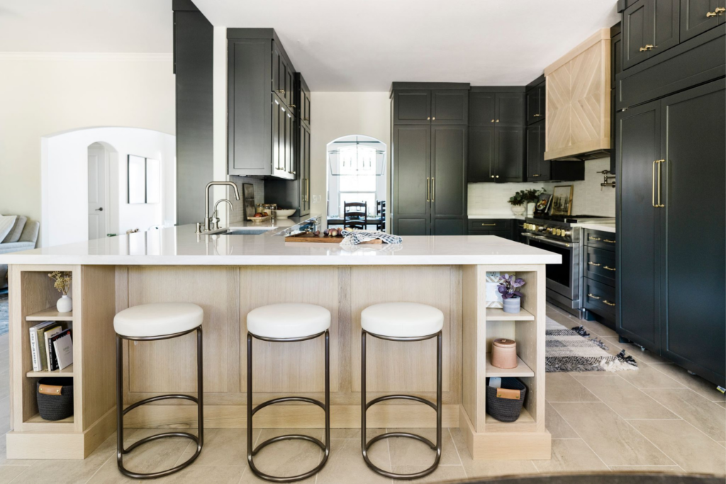 black kitchen design renovation white counters black cabinets bronze bar stools emerald forest 78259