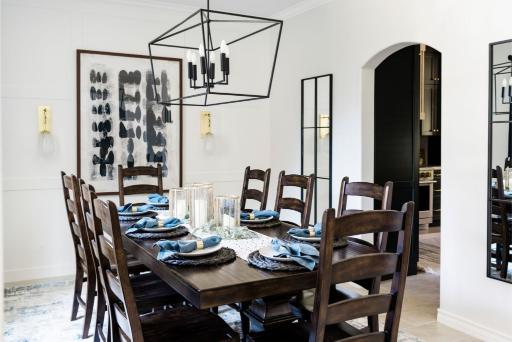moody fresh dining room design dramatic light fixture dark wood chairs abstract art satx