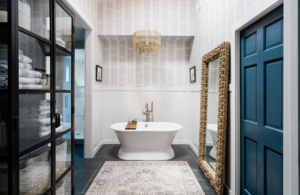 primary bathroom design standing bathtub wallpaper wainscoting coastal sophisticated relaxing