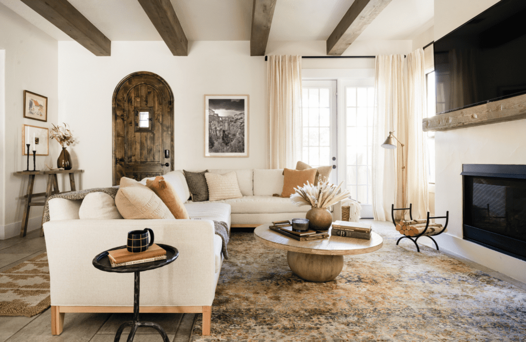 styleberry-creative-interiors-emerald-forest-tx-warm-earth-tone-living-room-renovation-reveal-neutral-sectional-round-coffee-table-ceiling-beams-boho-natural-design