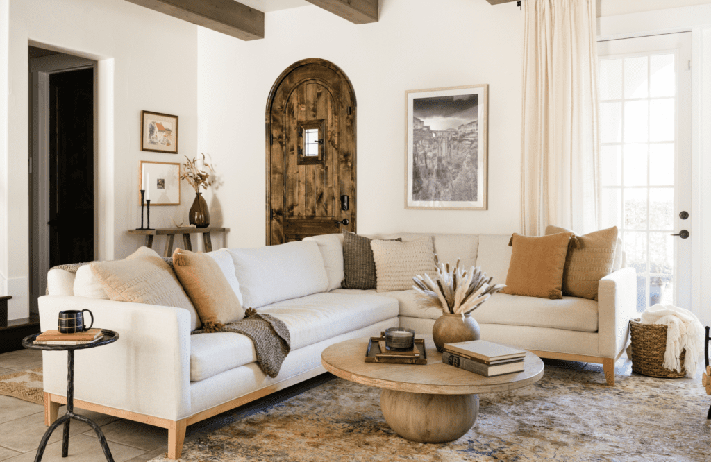 styleberry-creative-interiors-san-antonio-tx-earth-tones-mediterranean-inspired-living-room-neutral-sectional-round-wood-coffee-table-soft-styling-decor-warm-hues