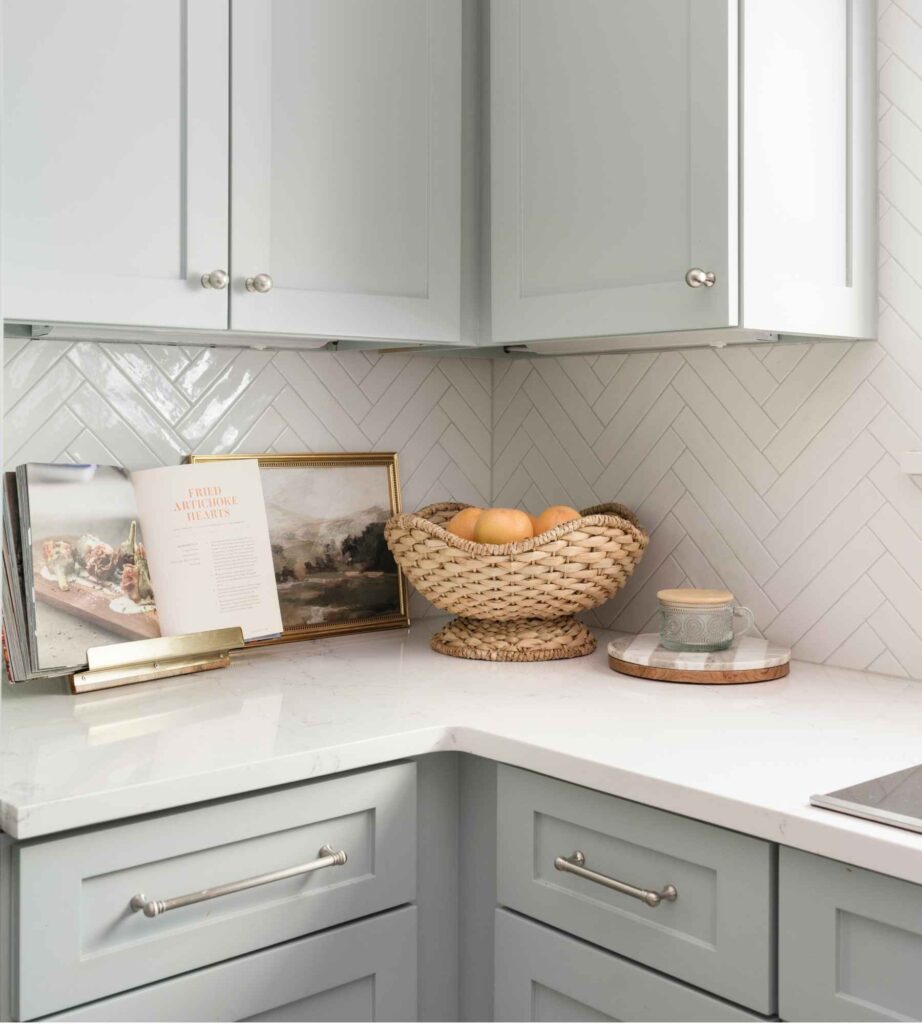 interior-designer-hunters-creek-tx-mixing-and-matching-design-services-renovated-kitchen-with-white-backsplash-tile-light-cabinets-natural-design