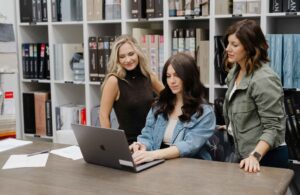 styleberry-creative-interiors-emerald-forest-tx-how-to-communicate-with-your-designer-shawna-percival-and-team-working-in-showroom-on-laptop-fresh