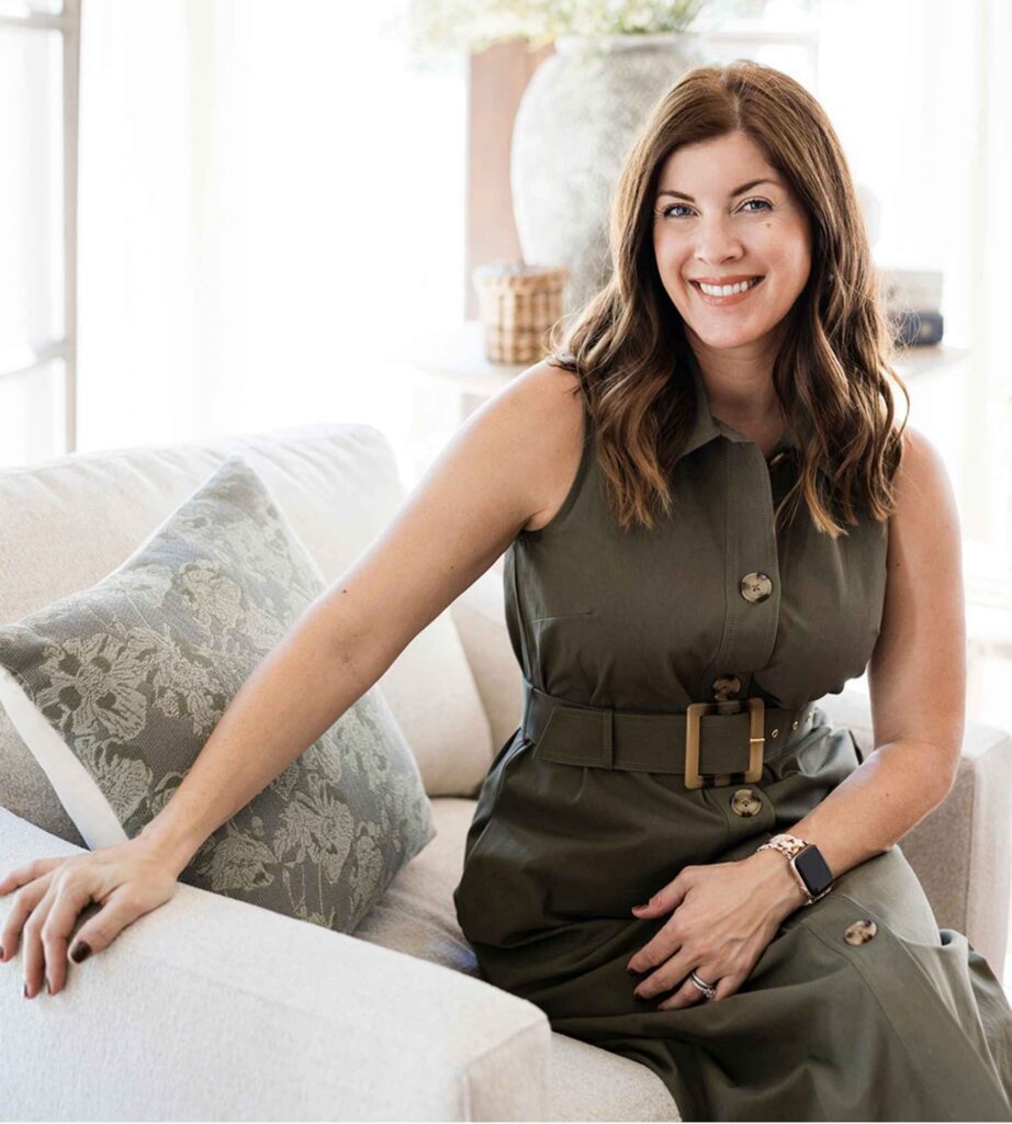styleberry-creative-interiors-emerald-forest-tx-new-design-consultation-services-shawna-percival-sitting-on-sofa-fresh-design